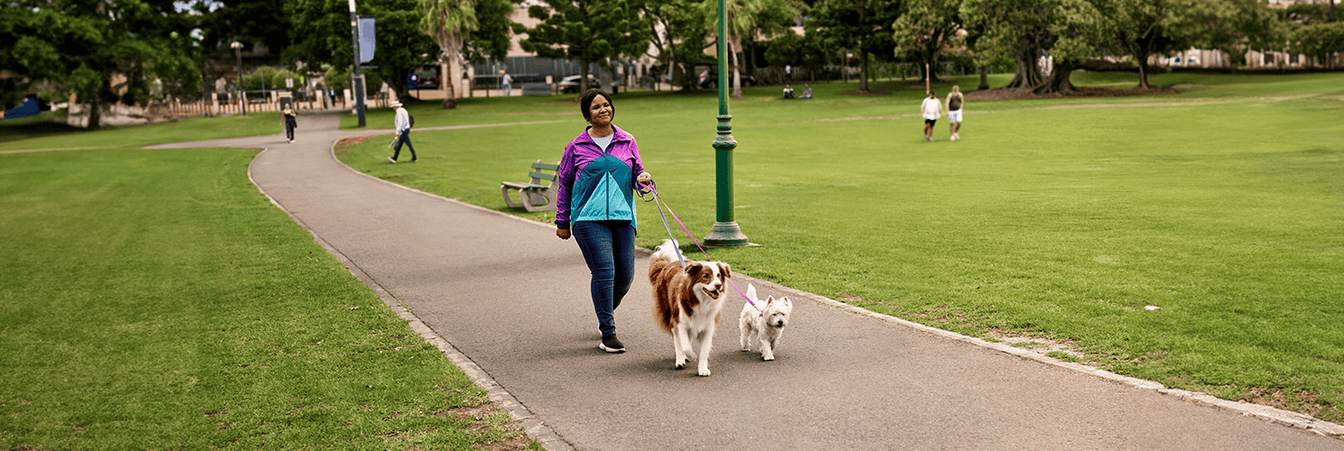 Woman walking two dogs