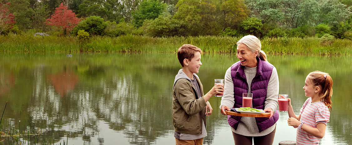 An older woman with two children on a pier